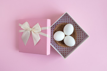Eggs with nest in rose gift box easter holiday abstract.
