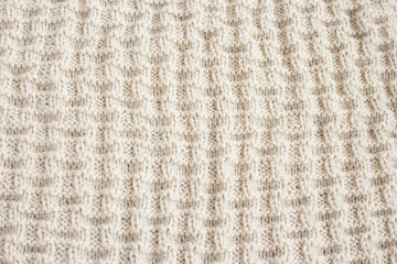 Knitted background in natural color. Knitted texture with space to place text.