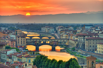 View of the River Arno and famous bridge Ponte Vecchio. Amazing evening golden hour light. Beautiful gold sunset in Florence, Italy - obrazy, fototapety, plakaty