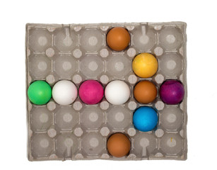 Beautiful creative arrow made of colored eggs in a tray. Pointer or cursor from eggs. Top view and flat lay.
