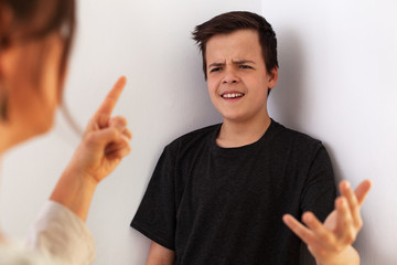 Woman having a fight with her teenager son - gesturing and expressing disagreement