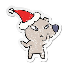 cute distressed sticker cartoon of a bear wearing santa hat