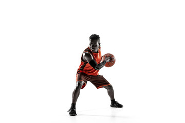Naklejka na ściany i meble Full length portrait of a basketball player with a ball isolated on white studio background. advertising concept. Fit african anerican athlete with ball. Motion, activity, movement concepts.