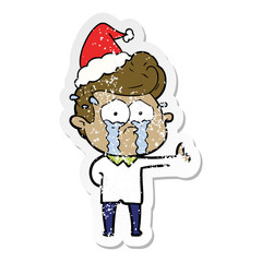 distressed sticker cartoon of a crying man wearing santa hat