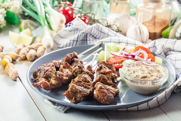 Traditional pork satay with peanut sauce and vegetables