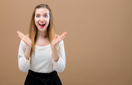 Happy young woman on a brown background