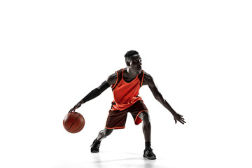 Naklejka premium Full length portrait of a basketball player with a ball isolated on white studio background. advertising concept. Fit african anerican athlete with ball. Motion, activity, movement concepts.