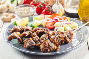 Traditional pork satay with peanut sauce and vegetables