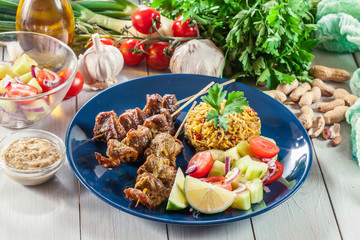 Traditional pork satay with peanut sauce and vegetables