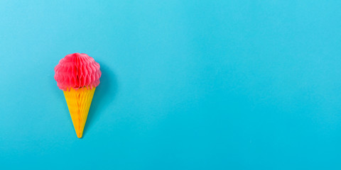 Ice cream cone party decoration on a blue paper background