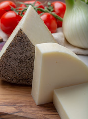 Italian cheeses, mature Tuscan Pecorino sheep cheese and Provolone dolce cow cheese served with olive bread and tomatoes