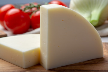 Italian cheese, Provolone dolce cow cheese from Cremona served with olive bread and tomatoes