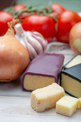 Mini black and dark red waxed cheddar cheeses with strong flavor made from West Country milk and and age-old methods with onion and garlic in England