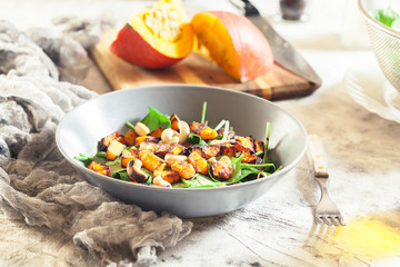 Roasted pumpkin salad with spinach and nuts