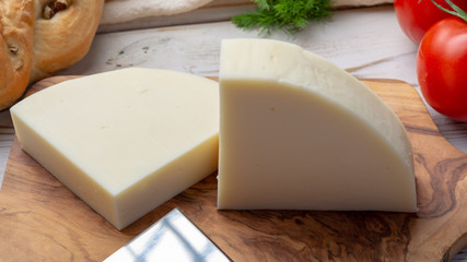 Italian cheese, Provolone dolce cow cheese from Cremona served with olive bread and tomatoes