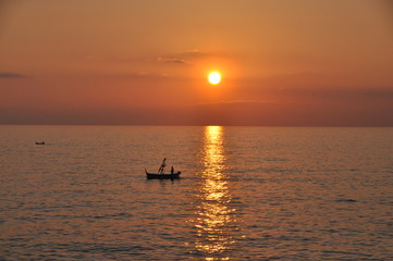 Fototapeta premium fishing boat at sunset in Camogli, Genoa province, Liguria, Italy