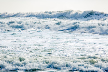 Strong and dangerous storm in the Black sea. Beautiful and large storm surge in the Bay of Gelendzhik in Gelendzhik. sea foam, wave crests, clear green water. 