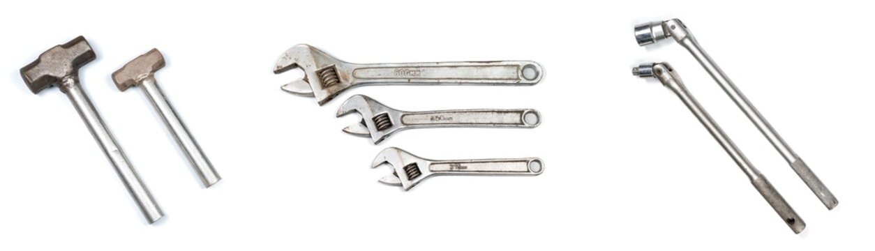 Set of various metal heavy duty industrial hand tools on a isolated white background - mallet hammer adjustable wrench and ratcheting socket wrench ratchet equipment
