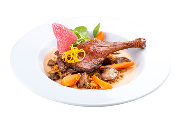 Duck leg with lentils and mushrooms on a white background