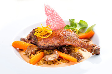 Duck leg with lentils and mushrooms on a white background