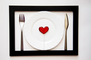 heart on a plate with fork and knife