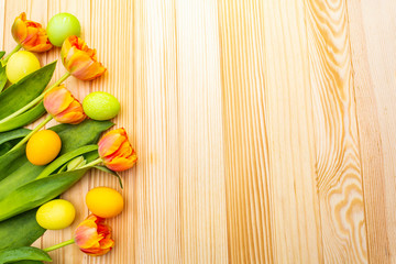 Easter spring concept. Gentle tulip and eggs on wooden background. Card, wallpaper, copy space.