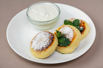 pancakes with powdered sugar and sour cream