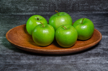 green apples on wooden table