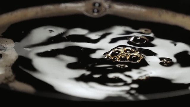Close up shot of fresh coffee in a cup in slow motion