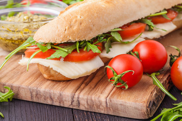 Close up of freshly made sandwich on wooden cutting board