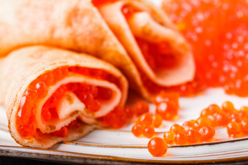 Delicious pancakes with red caviar