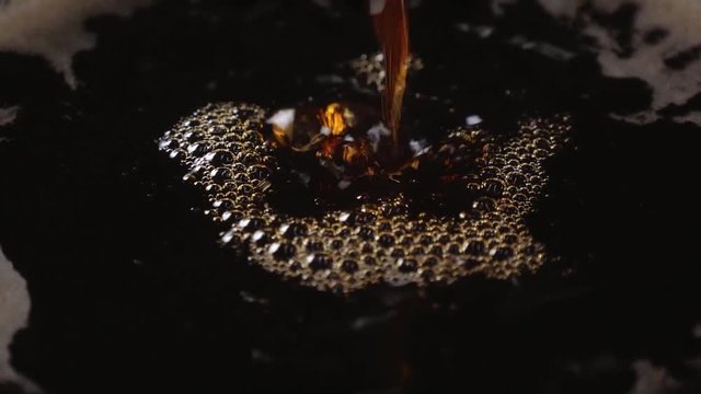 Close up shot of fresh coffee in a cup in slow motion