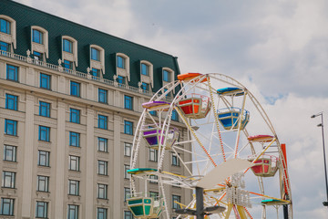 Ferris wheel on background of beautiful building
