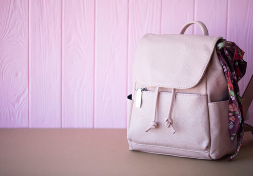 female pink leather backpack isolated 