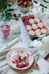 Fresh strawberry cobbler with with vanilla ice cream. Healthy breakfast