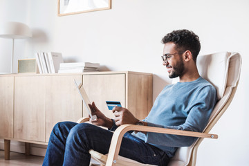 Young men using digital tablet with credit card. Businessman or entrepreneur working. Online...