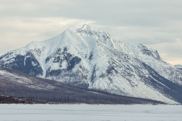 Snow covered mountain overlooking Lake McDonald, Glacier National Park, Montana in winter