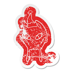 confused cartoon distressed sticker of a cat wearing santa hat