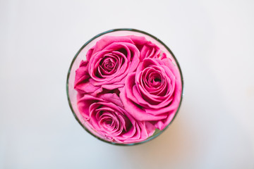 Top view of pink roses in glass table decoration