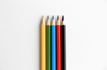 color pencils on white background top view.