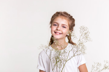 Cheerful little lady in white t-shirt actively posing