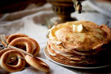 A stack of pancakes with a melting piece of butter.Russian tea party