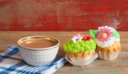 flower spring cupcake  with hot coffee cup on wooden table