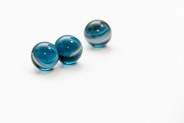 Colorful glass marbles on white background