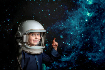 a small child wants to fly an airplane wearing an airplane helmet