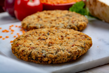 Tasty vegetarian food, raw burgers made from lentils legumes with vegetables ready for cooking