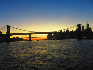 sunset at manhatten bridge with brooklyn bridge in background