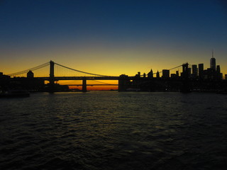 sunset at manhatten bridge with brooklyn bridge in background