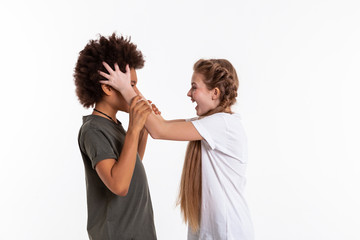Mad long-haired blonde girl yelling on her confused friend