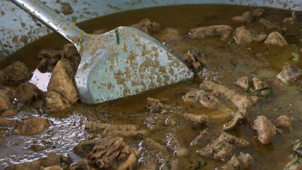 Chicken rendang (Rendang ayam) in a big pan - A kind of Malay traditional dish usually served during eid festival. Selective focus